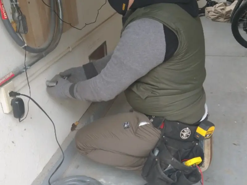 Electrician performing outlet wiring in a Healdsburg garage